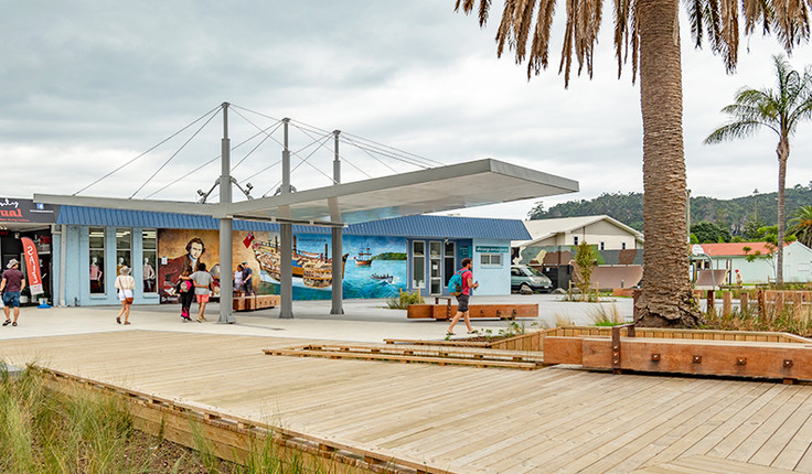 Coastal town waterfront with a timber boardwalk and public frontage